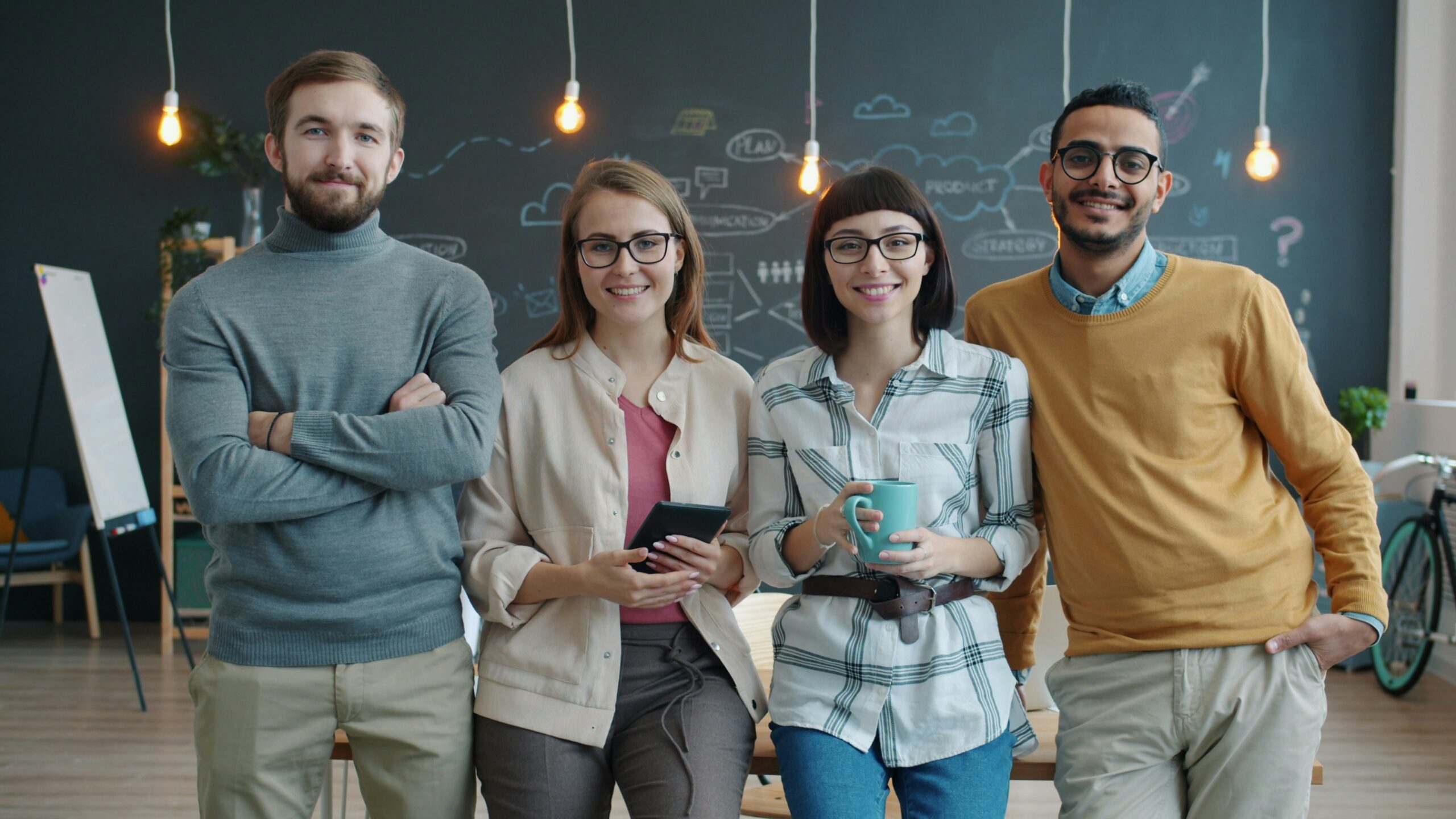 Cheerful team of business professionals smiling together in their office