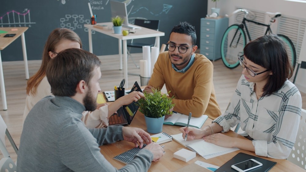 Diverse team discussing questions around a table